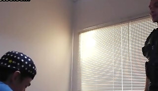 Submissive twink deepthroats police hunk in police station